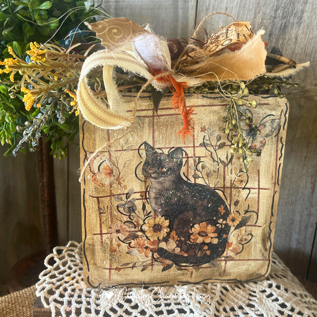 Hey Boo black shorthair kitty 6x6 wood block decor with whimsical cat wildflower butterfly artwork distressed aged wood background gold scroll cream ribbon bow rusty jingle bells and hey boo tag by Country Charm by Tracy