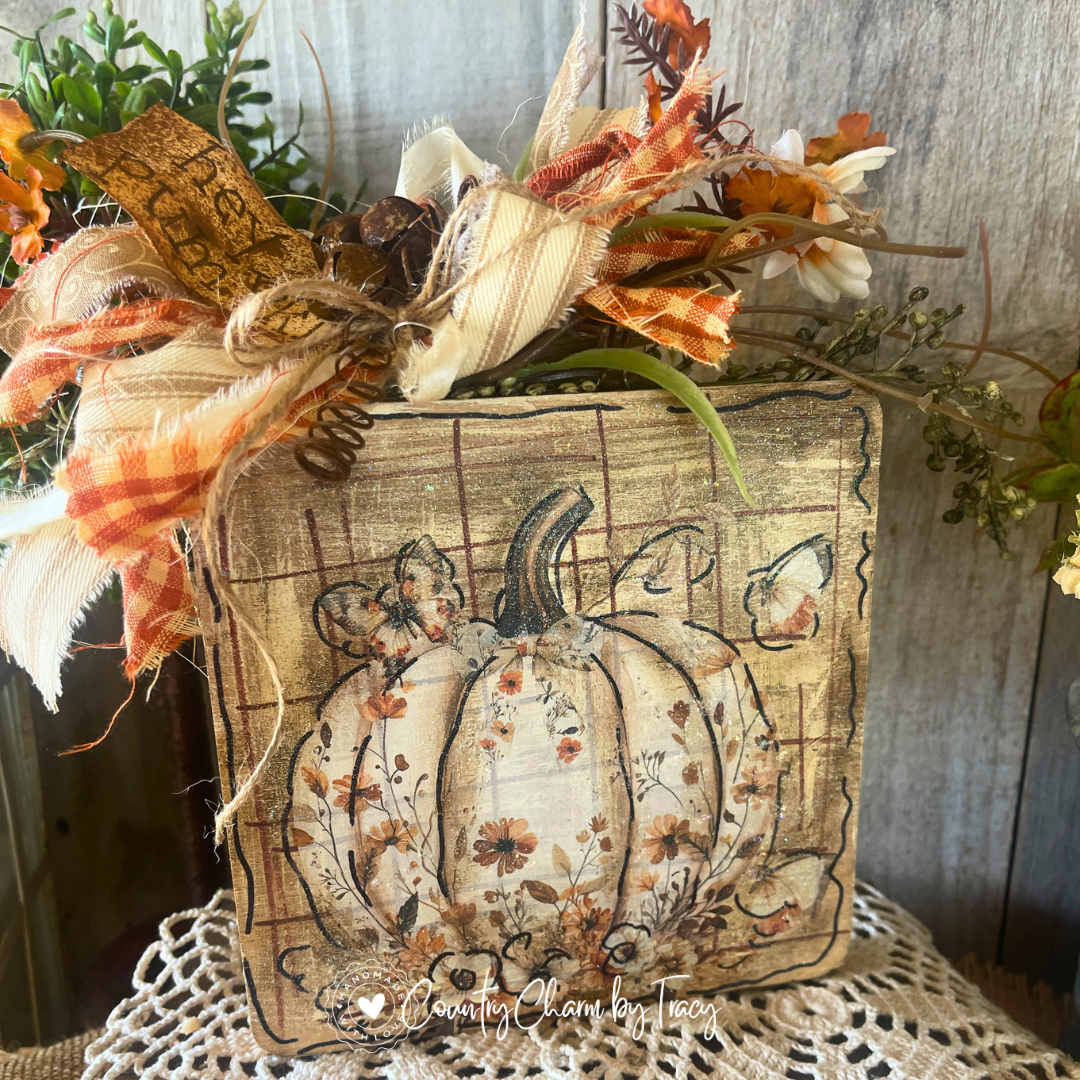 Hey Pumpkin floral pumpkin 6x6 wood block decor with cream ivory wildflower pumpkin artwork distressed aged wood background orange buffalo check cream ribbon bow rusty jingle bells curly wire and hey pumpkin tag by Country Charm by Tracy