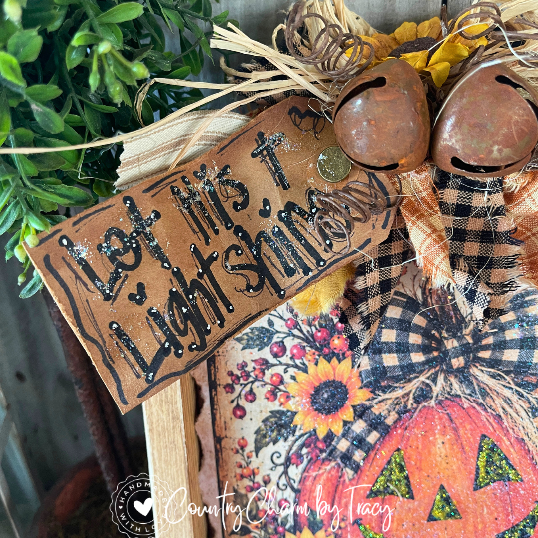 Close-up of Happy Jack pumpkin design with checked bow and sunflowers