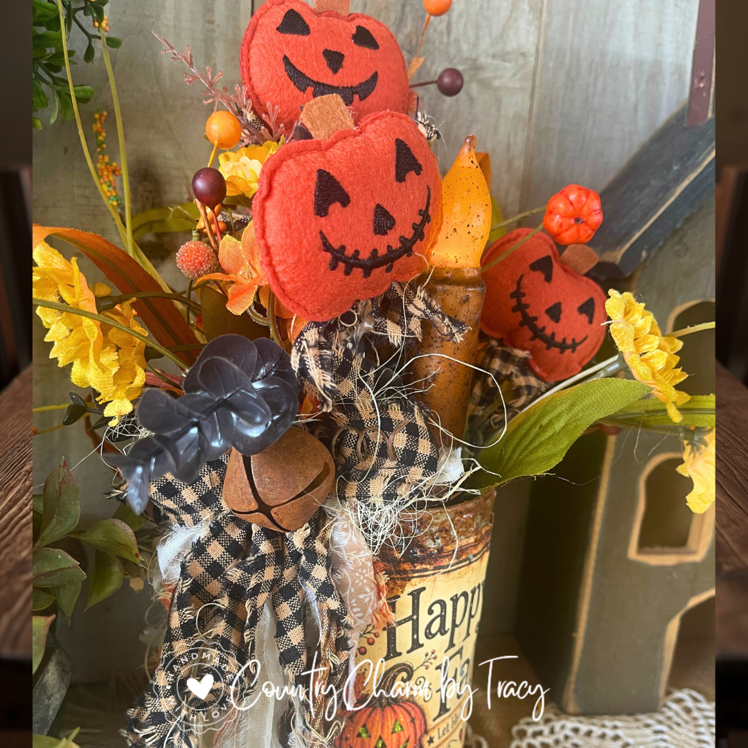 Layered black-and-tan homespun bow with rusty bell on Happy Fall tin can arrangement