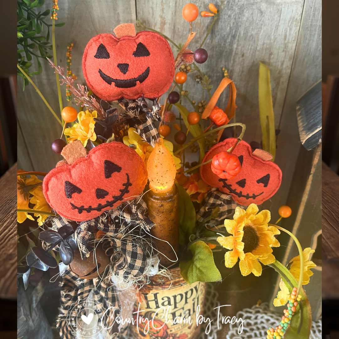 Close-up of felt pumpkins, primitive candle and autumn florals in 6-inch Happy Fall tin can decor