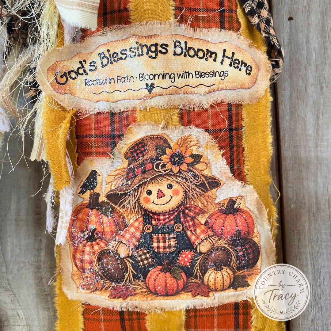 Fall scarecrow floral pocket displayed with pumpkins, florals, pine cones and greenery